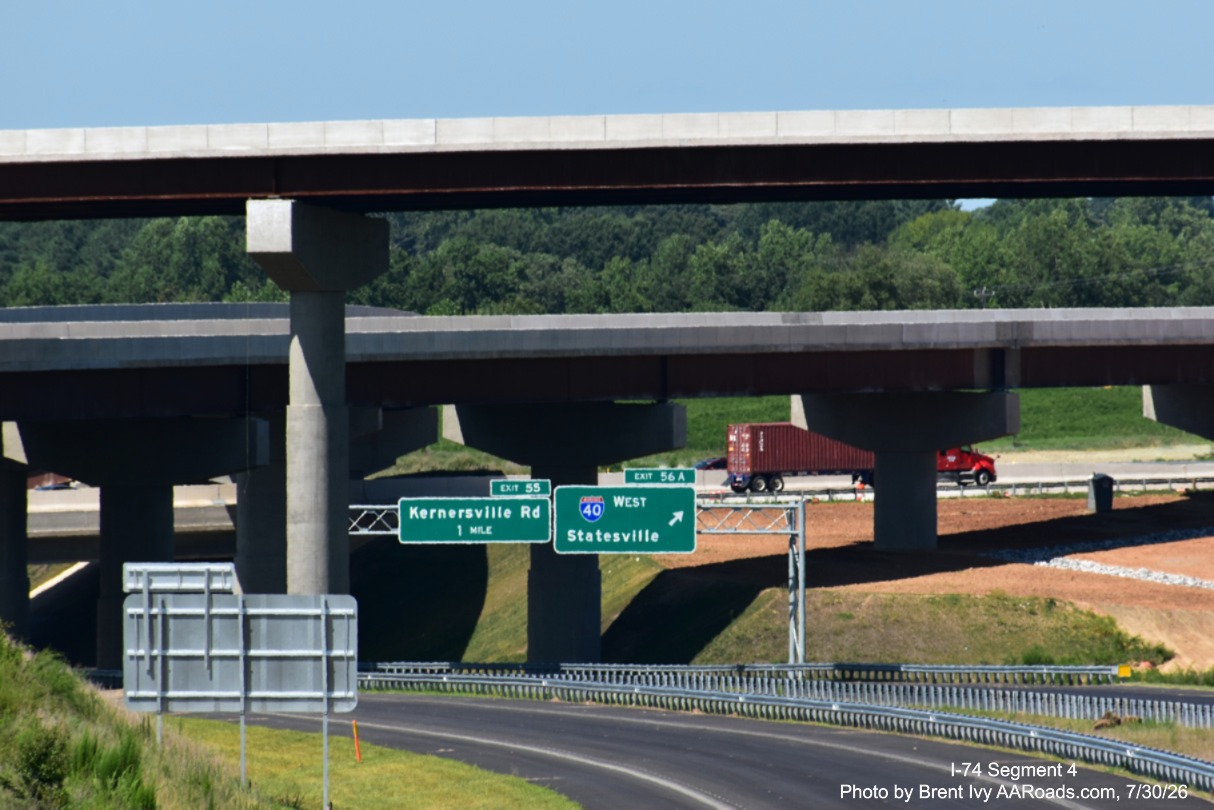 Image of I-74 roadway heading towards I-40 interchange with completed exit
	 signs for I-40 West and Kernersville Road, Brent Ivy at AARoads.com, July 30, 2026