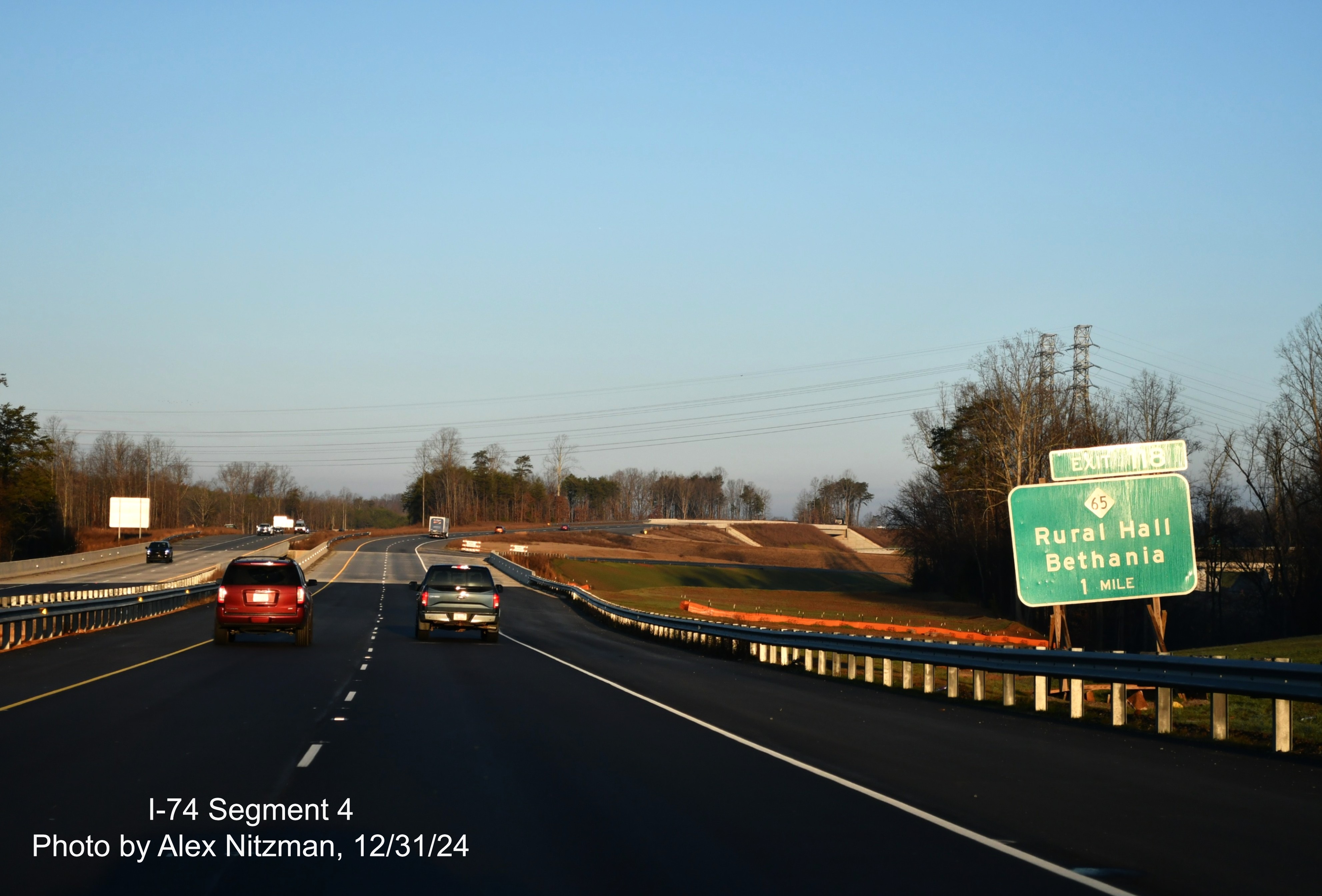 Image of old 1 Mile advance sign for NC 65 exit on US 52 North after future ramp to 
	  Winston-Salem Northern Beltway headed west, December 2024, Alex Nitzman