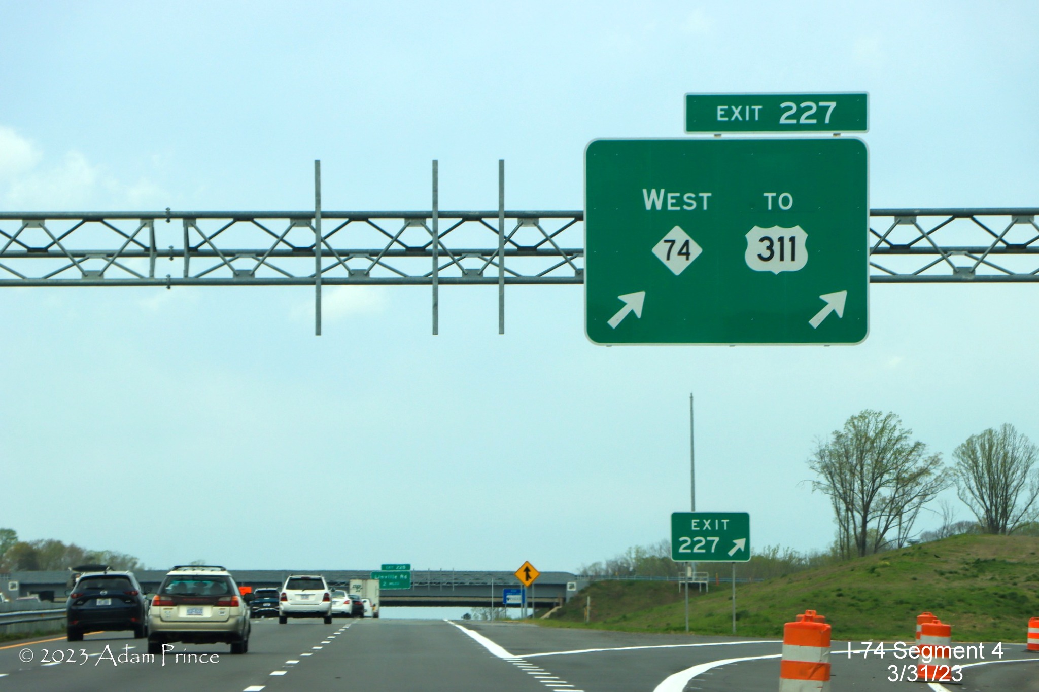 Image of overhead ramp sign for NC 74 (Future I-74) West/Winston-Salem Northern Beltway 
        exit on US 421 North/Salem Parkway, Adam Prince, March 2023