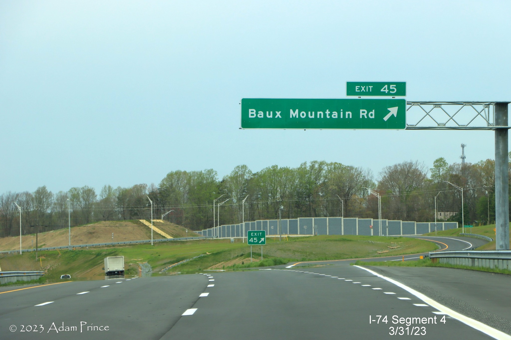 Image of overhead ramp sign for Baux Mountain Road exit on NC 74 (Future I-74) West/Winston-Salem 
        Northern Beltway, Adam Prince, March 2023