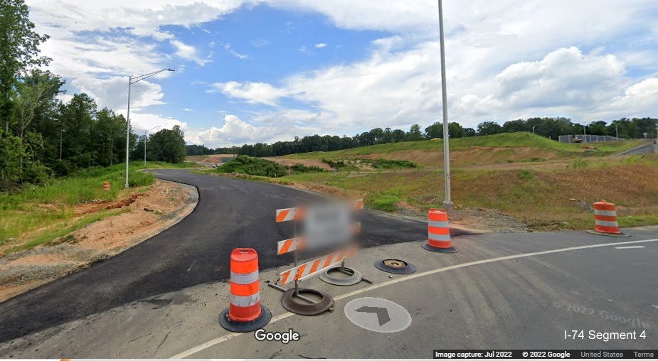 Image of new roundabout along Baux Mountain Road south of unopened Winston-Salem Northern 
          Beltway with future off-ramp from NC 74 (Future I-74) East, Google Maps Street View, July 2022