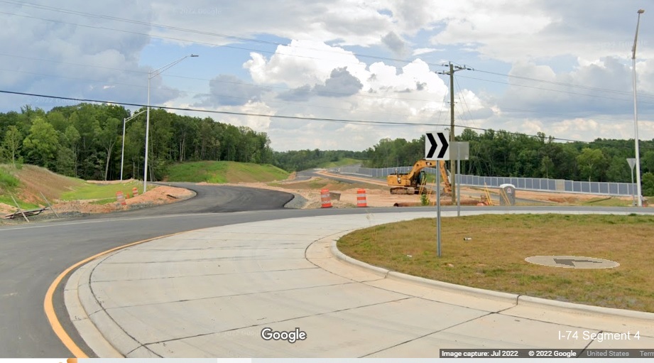 Image looking from Baux Mountain Road roundabout toward future off-
          ramp from unopened Winston-Salem Northern Beltway / NC 74 (Future I-74) West, Google Maps Street View, July 2022