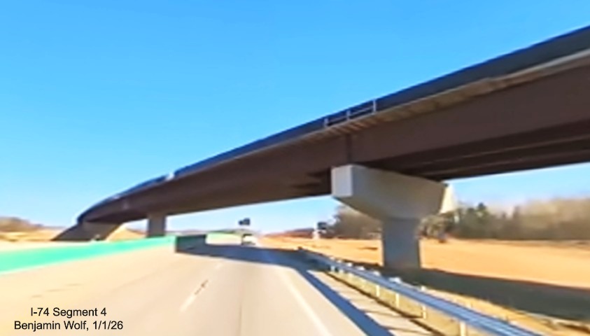 Image of future flyover ramp from I-40 West to I-74 East crossing over I-40 East in 
	  Winston-Salem Northern Beltway interchange project work zone, screen grab from Benjamin Wolf video, January 2026