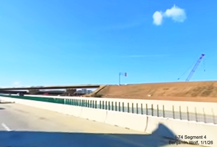 Image of overhead sign installed on flyover ramp as seen from I-40 East in the 
	  Winston-Salem Northern Beltway interchange project work zone, screen grab from Benjamin Wolf video, January 2026