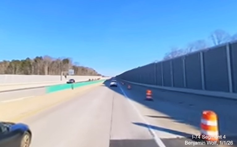 Image of noise walls on both sides of I-40 prior to the Union Cross Road exit in the 
	  Winston-Salem Northern Beltway interchange project work zone, screen grab from Benjamin Wolf video, January 2026