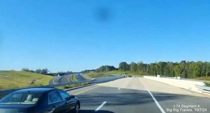 Screen grab of video showing traffic on US 52 North prior to the NC 74 West merge with traffic 
        seen on the new eastbound lanes of the Winston-Salem Northern Beltway, Big Rig Travels, October 2024