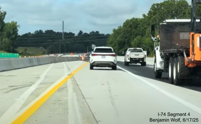 Image of traffic on I-40 West heading under flyover ramp for future ramp to
	  I-74 East/ Winston-Salem Northern Beltway, screen grab from Benjamin Wolf video, June 2025