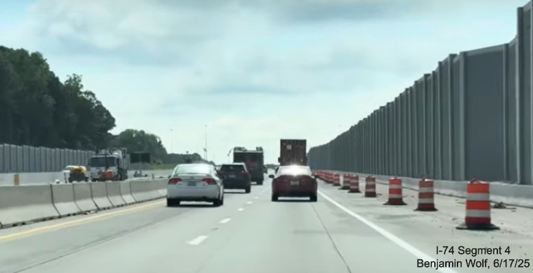 Image of traffic on I-40 East after the future on-ramp from
	  the I-74 West / Winston-Salem Northern Beltway surrounded by noise walls, screen grab from Benjamin Wolf video, June 2025