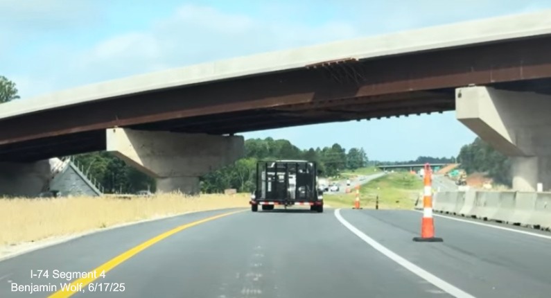 Image of traffic on I-74 East passing under the future off-ramp from NC 192
	  East to the Winston-Salem Northern Beltway interchange work zone, screen grab from Benjamin Wolf video, June 2025
