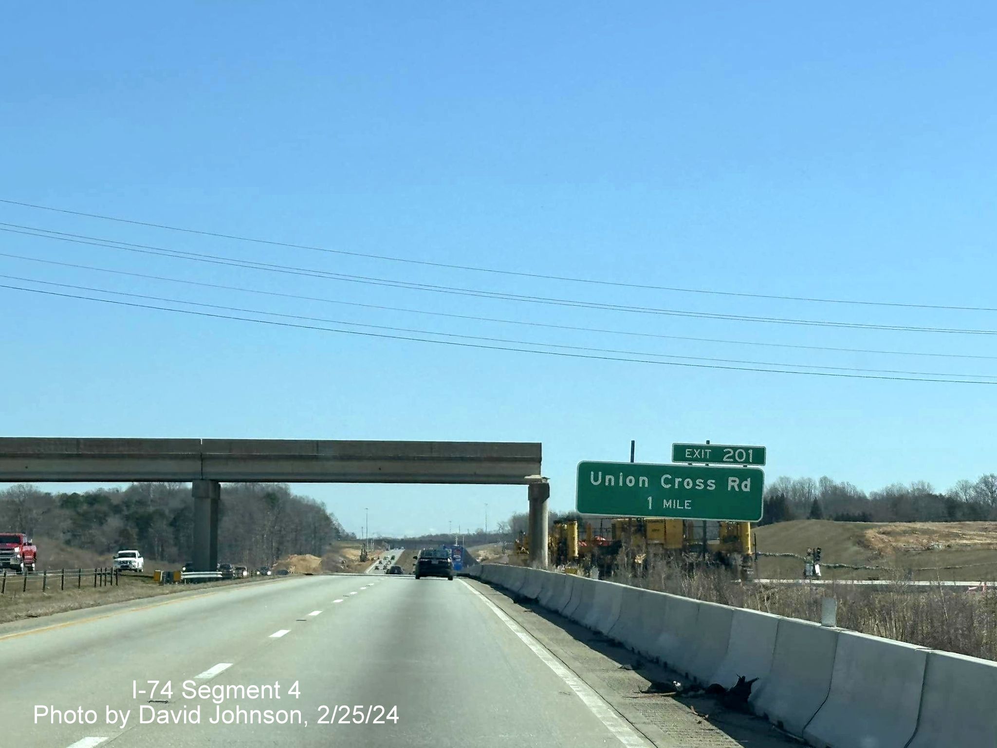 Image of still to be demolished bridge over I-40 East with future I-74/Winston-Salem 
        Northern Beltway west ramps in the distance in Forsyth County, by David Johnson, February 2024