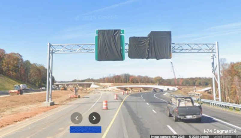 Image of covered up future overhead signage for I-40 and NC 192 exits on I-74 
	  West in work zone for  Winston-Salem Northern Beltway interchange after the Union Cross Road exit, Google Maps Street View, November 2025