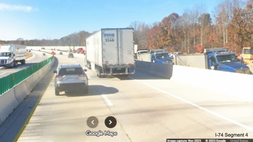 Image of current Future I-40 West lanes passing construction vehicles in future 
	  permanent lanes building noise walls in I-74 Winston-Salem Northern Beltway interchange construction zone, Google 
	  Maps Street View, November 2025