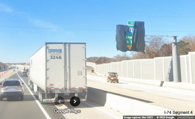 Image of Future I-74 exit sign only partly covered up along I-40 West after 
	  the Union Cross Road exit ramp, Google Maps Street View, November 2025