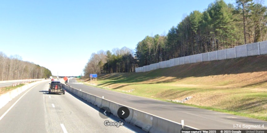Image of paved future eastbound lanes and the end of completed noise wall just 
	  before the Union Cross Road interchange on I-74 East, Google Maps Street View, March 2025