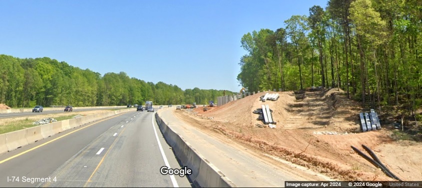 Image of noise wall construction along I-74 East in the Winston-Salem Northern Beltway 
        interchange work zone, Google Maps Street View, April 2024