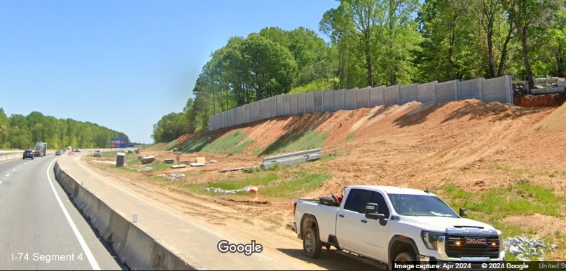 Image of completed noise wall along I-74 East in the Winston-Salem Northern Beltway interchange
        work zone, Google Maps Street View, April 2024