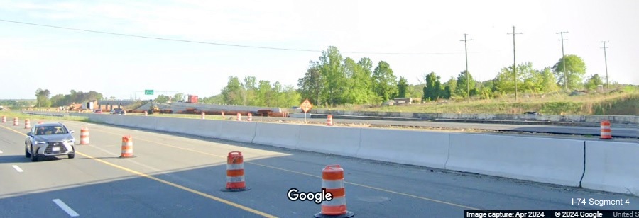 Image of NC 74 Beltway ramp construction as seen from US 52 North under the NC 65 bridge,
        Google Maps Street View, April 2024