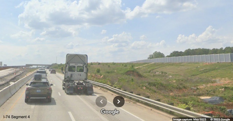 Image of noise walls continuing along the future off-ramp to the I-74 East/
	  Winston-Salem Northern Beltway from I-40 West, Google Maps Street View, May 2025