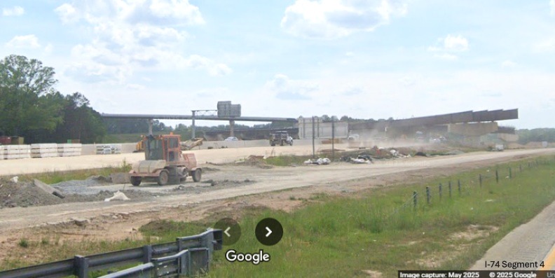 Image of future flyover ramps under construction from I-40 to the I-74/Winston-Salem 
	  Northern Beltway interchange seen across from the westbound lanes, Google Maps Street View, May 2025