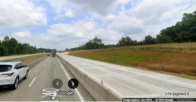 Image of cordoned off concrete roadway along I-40 East prior to future I-74/Winston-Salem 
        Northern Beltway off-ramp, Google Maps Street View, June 2024