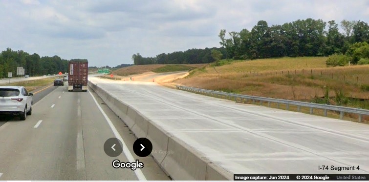 Image of cordoned off concrete roadway along I-40 East prior to future I-74/Winston-Salem 
        Northern Beltway off-ramp, Google Maps Street View, June 2024