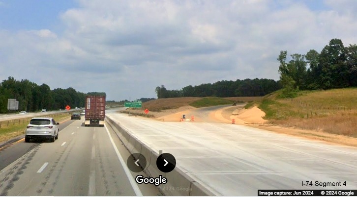 Image of cordoned off concrete roadway along I-40 East at future I-74/Winston-Salem 
        Northern Beltway off-ramp, Google Maps Street View, June 2024