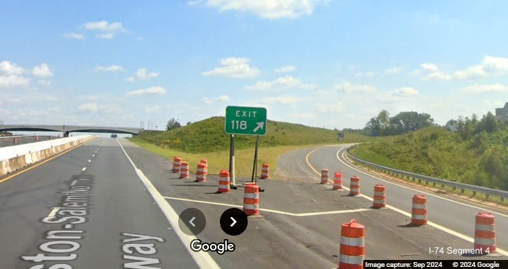 Image of temporary gore sign for NC 65 exit surrounded by construction barrels on US 52 South in 
      Winston-Salem Northern Beltway construction zone, Google Maps Street View, September 2024