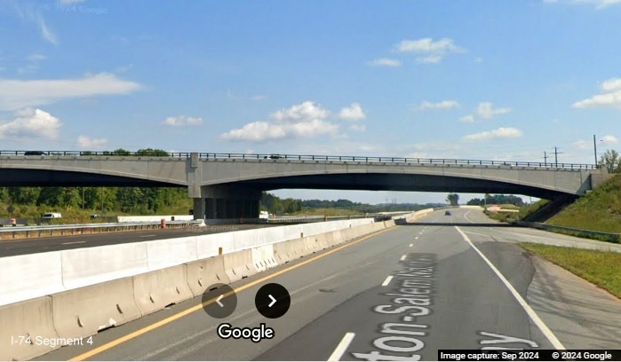 Image of temporary gore sign for NC 65 exit surrounded by construction barrels on US 52 South in 
      Winston-Salem Northern Beltway construction zone, Google Maps Street View, September 2024