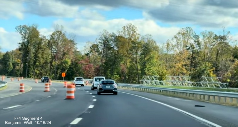 Image of the storage of future sign supports along the new NC 74 (Future I-74) 
        Winston-Salem Beltway lanes after the western section bridge, screen grab from Benjamin Wolf video, October 2024