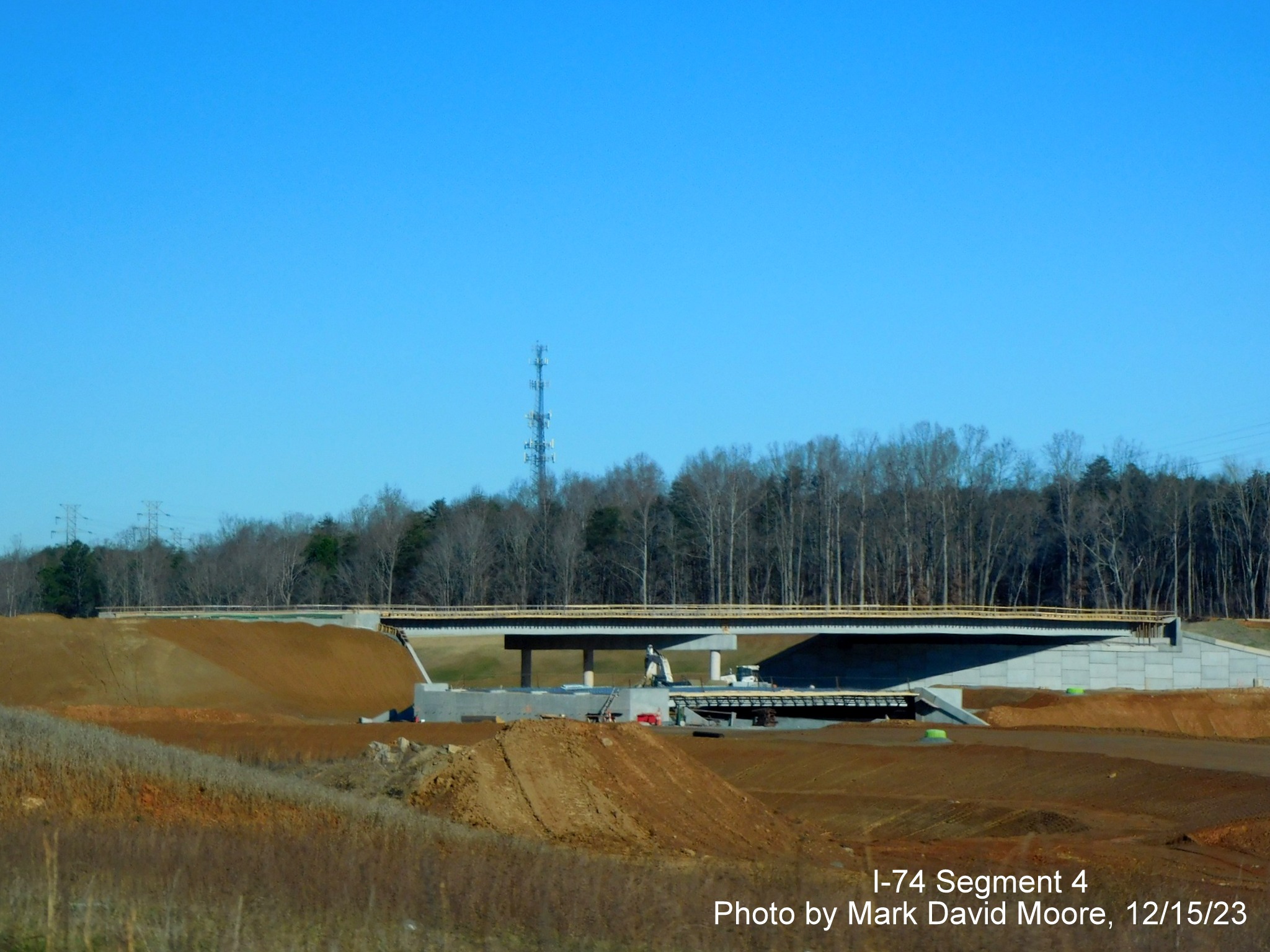 Image from US 52 North of future ramp construction from NC 74 West to US 52 South and work
        on the future NC 74 East roadway, by Mark David Moore, December 2023