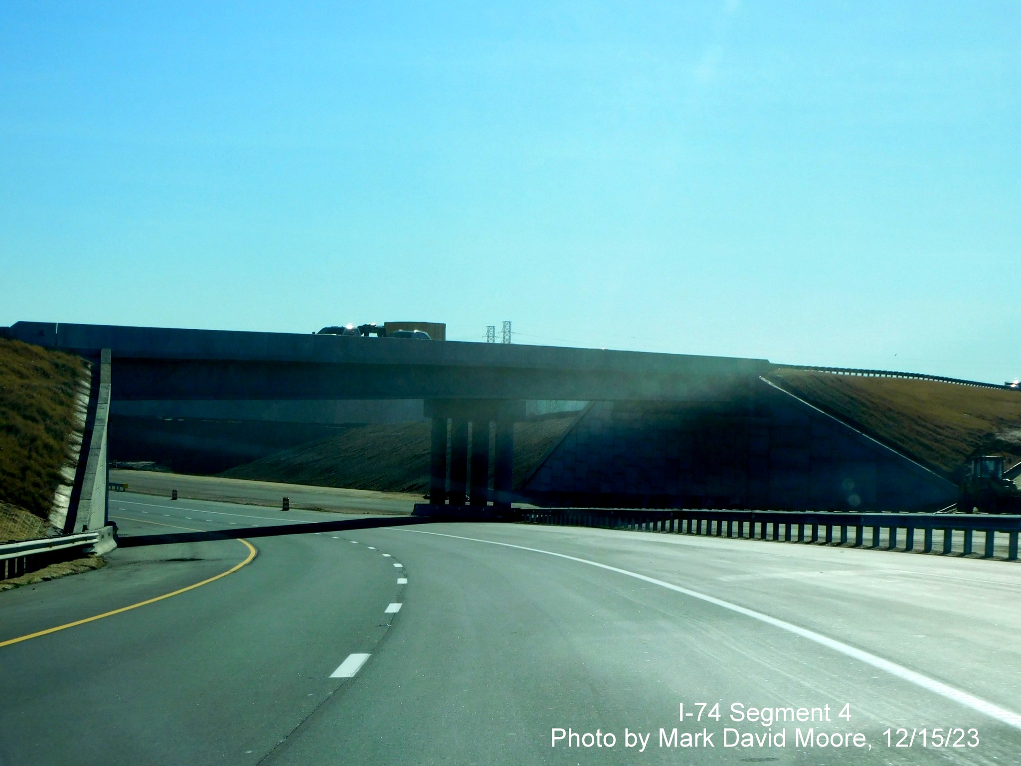 Image of NC 74 East/Winston-Salem Northern approaching the US 52 North bridge temporarily using
      the future westbound roadway, by Mark David Moore, December 2023