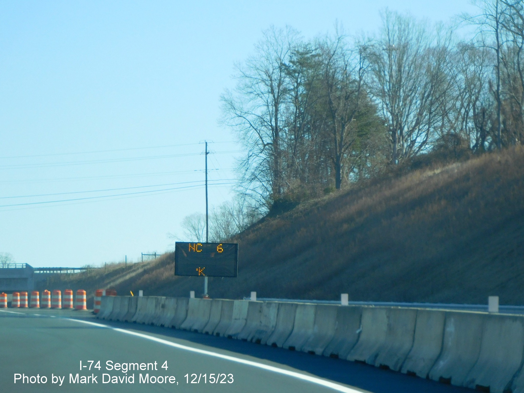 Image of VMS being used as temporary ramp sign for NC 66/University Parkway exit on NC 74 (Future I-74) 
        East after segment from US 52 South opened, from video by Tar Heel Dashcam, December 2023