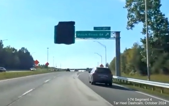 Image of covered over, newly placed, advance sign for I-74/Winston-Salem Beltway exit at 
        ramp to Union Cross Road on I-40 West, screen grab from Tar Heel Dashcam video, October 2024