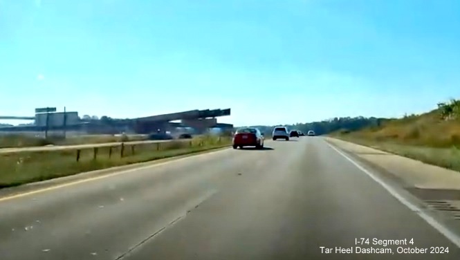 Image of supports for future flyover ramps for I-74/Winston-Salem Beltway exit at 
        I-40 West, screen grab from Tar Heel Dashcam video, October 2024