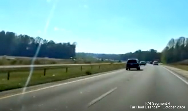 Image of relocated I-40 East lanes after future I-74/Winston-Salem Beltway exit as 
        seen from I-40 West, screen grab from Tar Heel Dashcam video, October 2024