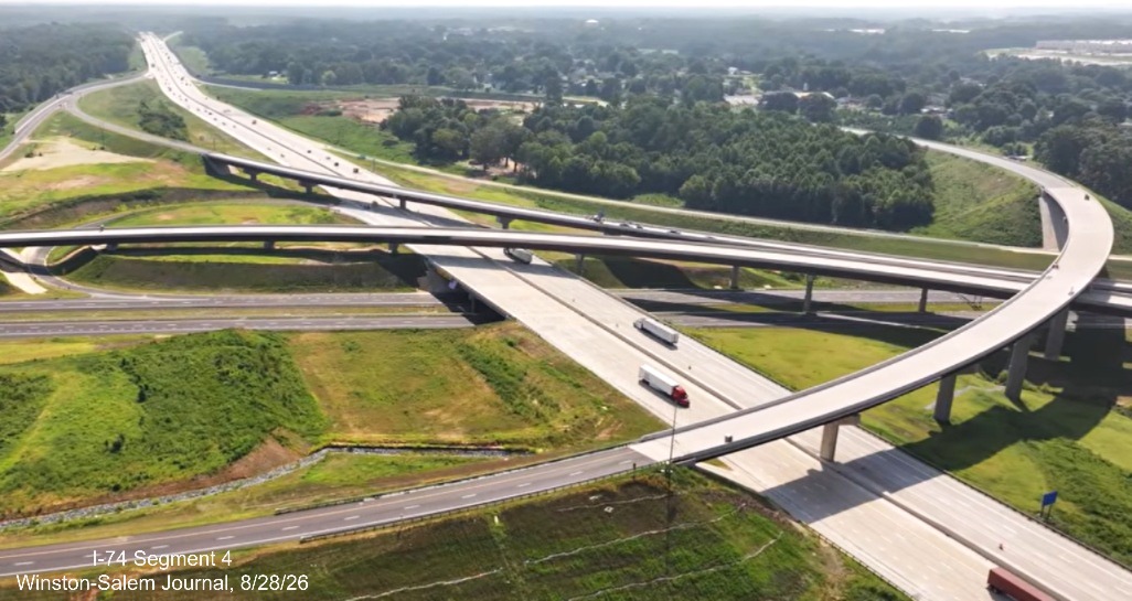 Image from Winston-Salem Journal video above the nearly completed I-40/I-74 
	 Beltway interchange after the official ribbon cutting ceremony, August 2026