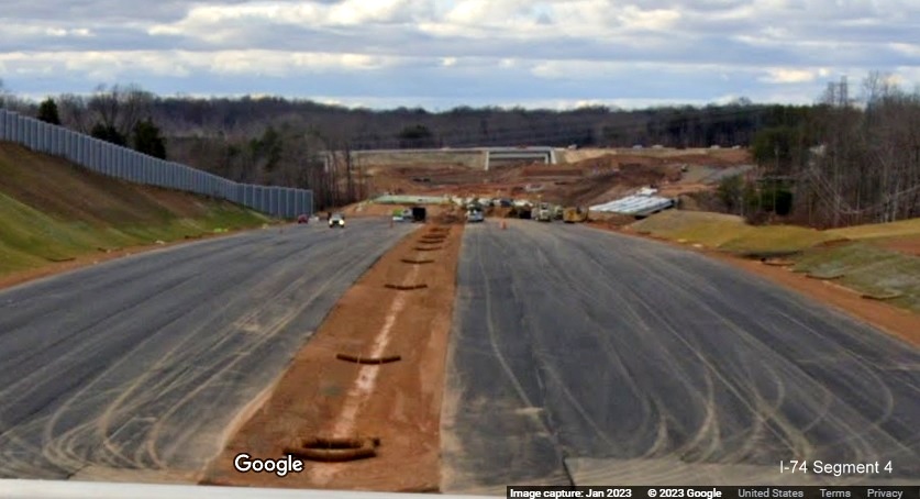 Image of view west from NC 66/University Parkway bridge toward future Winston-Salem Northern Beltway 
        exit with US 52, Google Maps Street View, January 2023