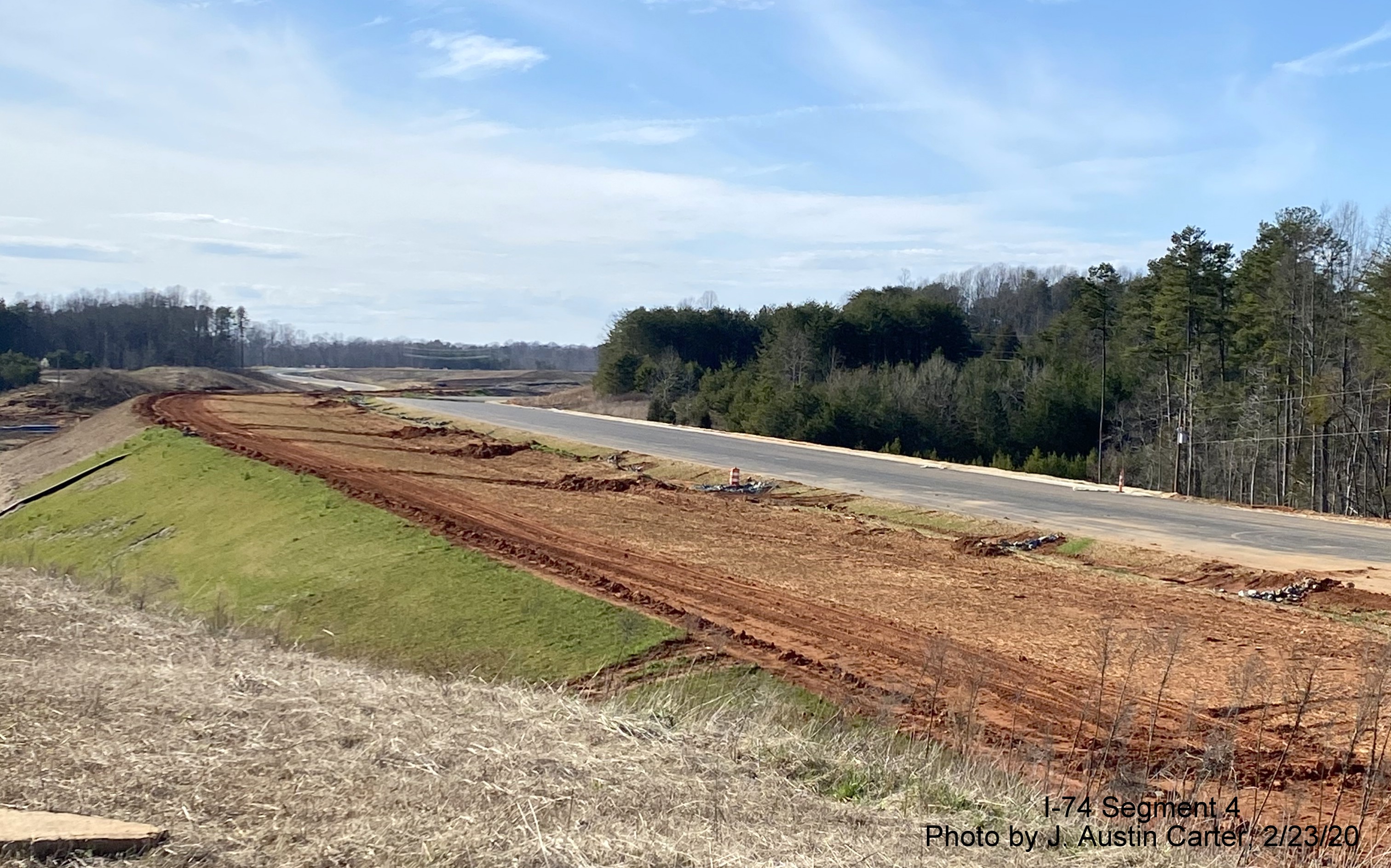 Image of road construction in vicinity of Dillon Farm Road looking west along roadbed of 
        future I-74/Winston-Salem Beltway toward US 311, by J. Austin Carter in Feb. 2020