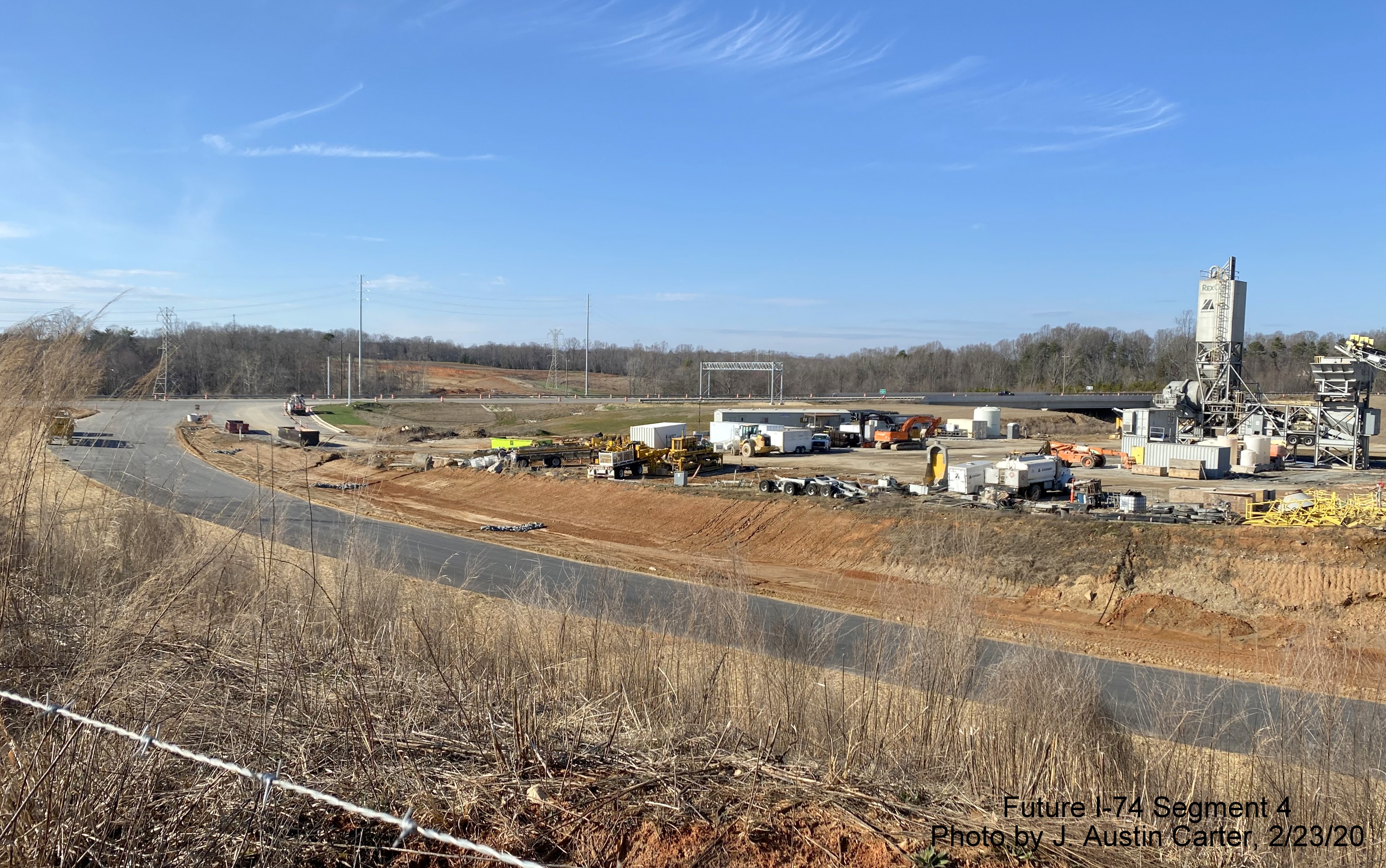 Image of on-ramp from US 158 to future I-74 East/Winston-Salem Beltway with temporary
        concrete plant in middle of interchange, by J. Austin Carter in Feb. 2020