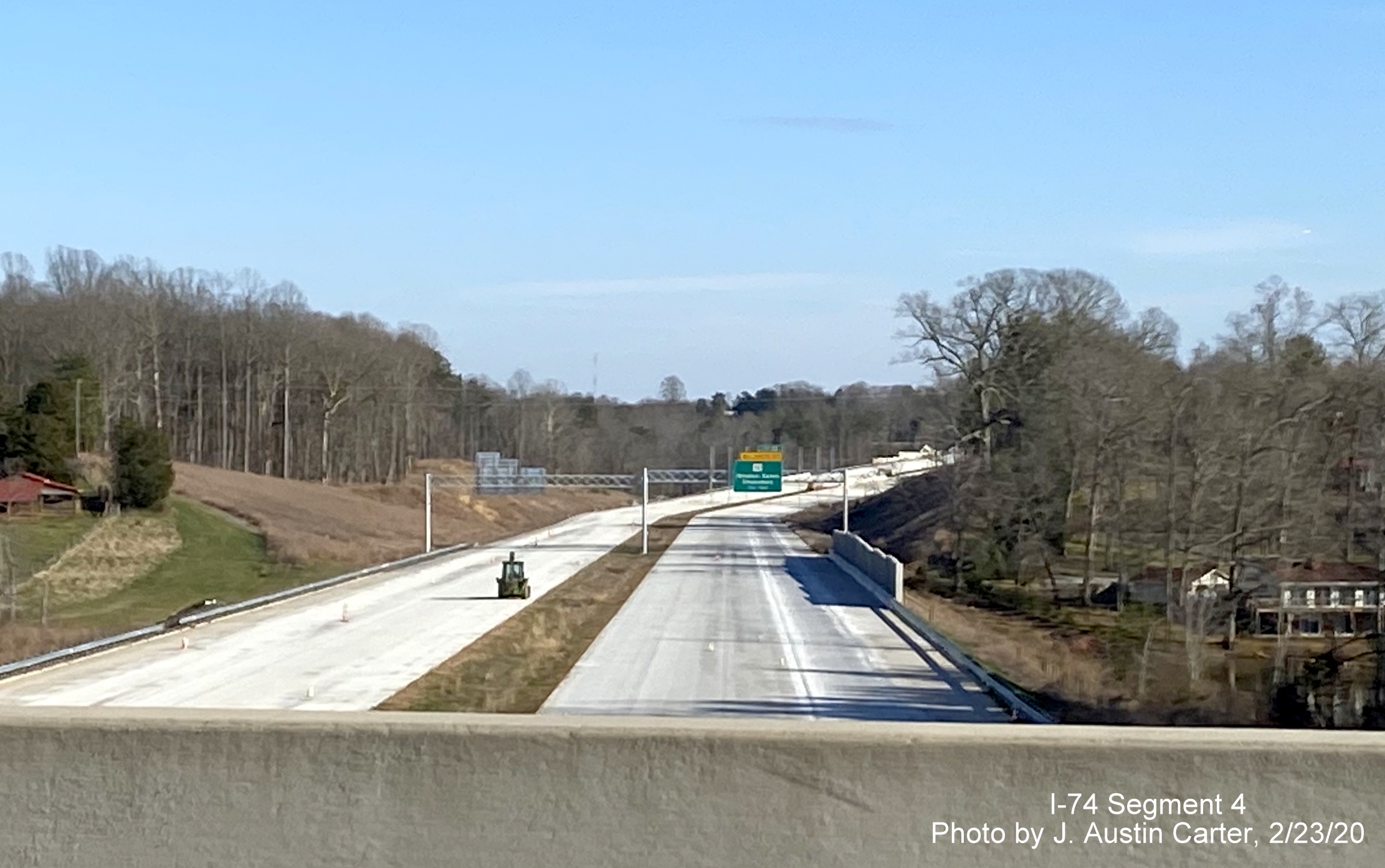 Image of new overhead signs being placed along future I-74/Winston-Salem Beltway for 
        US 421 and US 158 exits from Old Belews Creek Road bridge, by J. Austin Carter in Feb. 2020