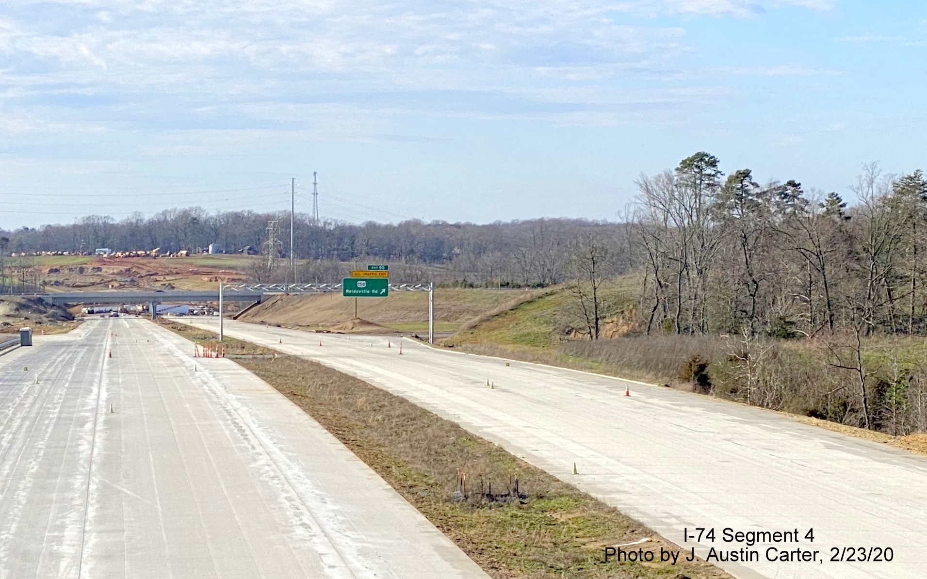 Image newly placed overhead exit ramp sign for US 158 on Future I-74 West/
        Winston-Salem Beltway, by J. Austin Carter in Feb. 2020