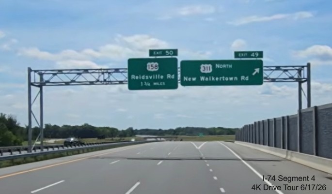 Image of overhead signage at ramp for New Walkertown Road exit now the North 
	  added next to the US 311 shield on NC 74 East, screen grab from 4K Drive Tour video, June 17, 2026