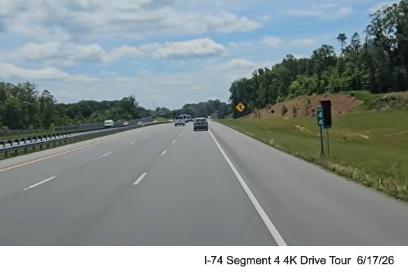 Image of covered up I-74 milepost next to NC 74 version along the
	  Beltway headed east, screen grab from 4K Drive Tour video, June 17, 2026