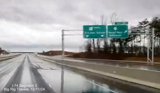 Image of newly placed overhead signs at ramp for NC 65 exit on US 52 South after the split from NC 74
       (Future I-74) East in Rural Hall, screen grab from Big Rig Travels video, December 2024