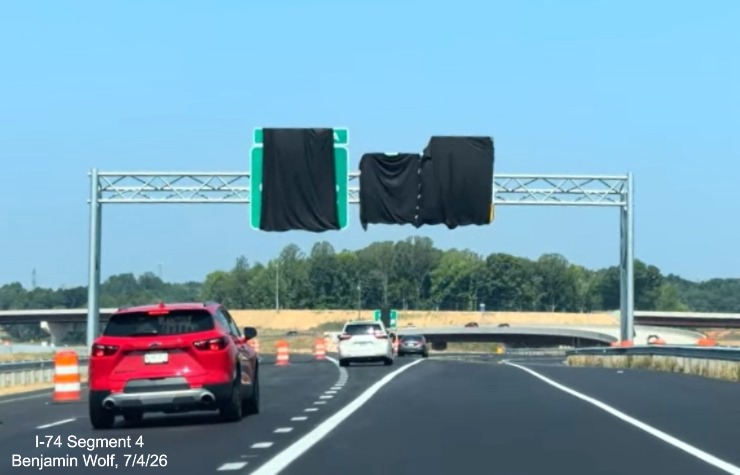 Image of overhead signage at the furure split with the West I-74 Beltway lanes
	 from NC 192 West. Notice the lane markings have been placed for the Beltway lanes, screen grab from Benjamin Wolf video, 
	 July 4, 2026