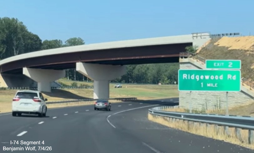 Image of new 1 mile advance sign for the Ridgewood Road exit prior to NC 192 to
	 I-74 West Beltway ramp bridge, screen grab from Benjamin Wolf video, July 4, 2026