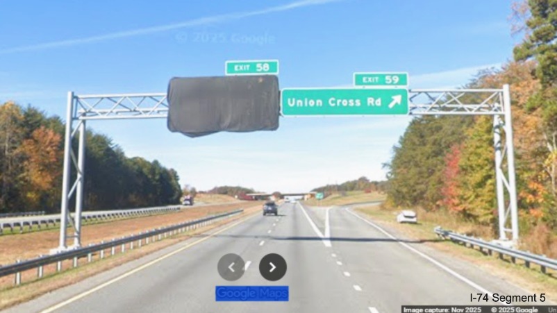 Image of overhead signage at the Union Cross Road exit on I-74 West, with
	  future NC 192 exit covered over except for Exit 58 tab, Google Maps Street View, November 2025