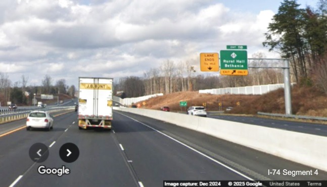 Image of recently placed ramp sign for NC 65 exit on US 52 North lanes as seen from NC 74 
	  West at end of Winston-Salem Northern Beltway (Future I-74), December 2024