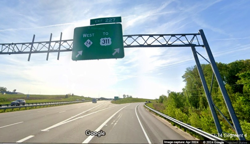 Image of overhead exit sign for West NC 74 (Future I-74) exit sign not updated to reflect 
        extension to US 52, Google Maps Street View, April 2024