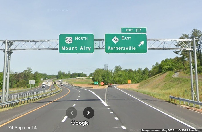 Image of workers installing a variable message sign next to 1/4 mile advance
	  overhead sign for NC 74 Winston-Salem Northern Beltway interchange on US 52 North in Rural Hall, Google Maps Street View, 
	  May 2025